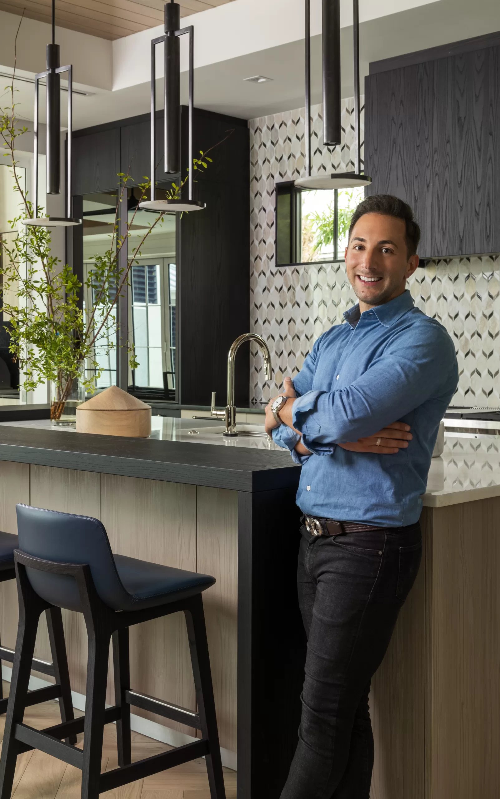 L.A. DeRiggi owner and principal designer of Hudson Park Interior Design posing in a contemporary kitchen design