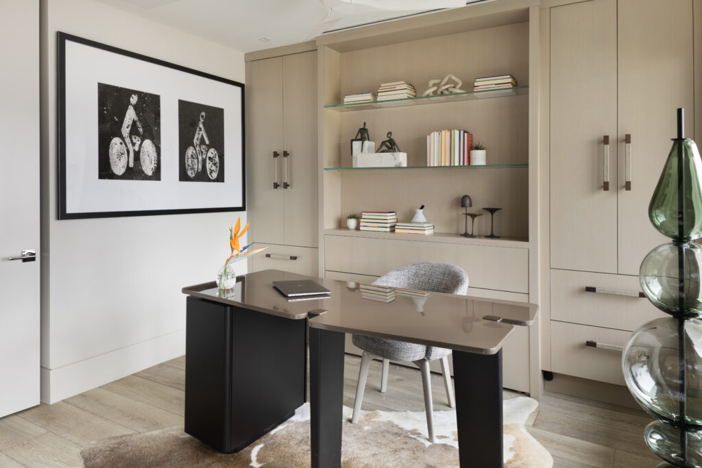 Home office interior design with custom furniture and built-in cabinets and bookcase.