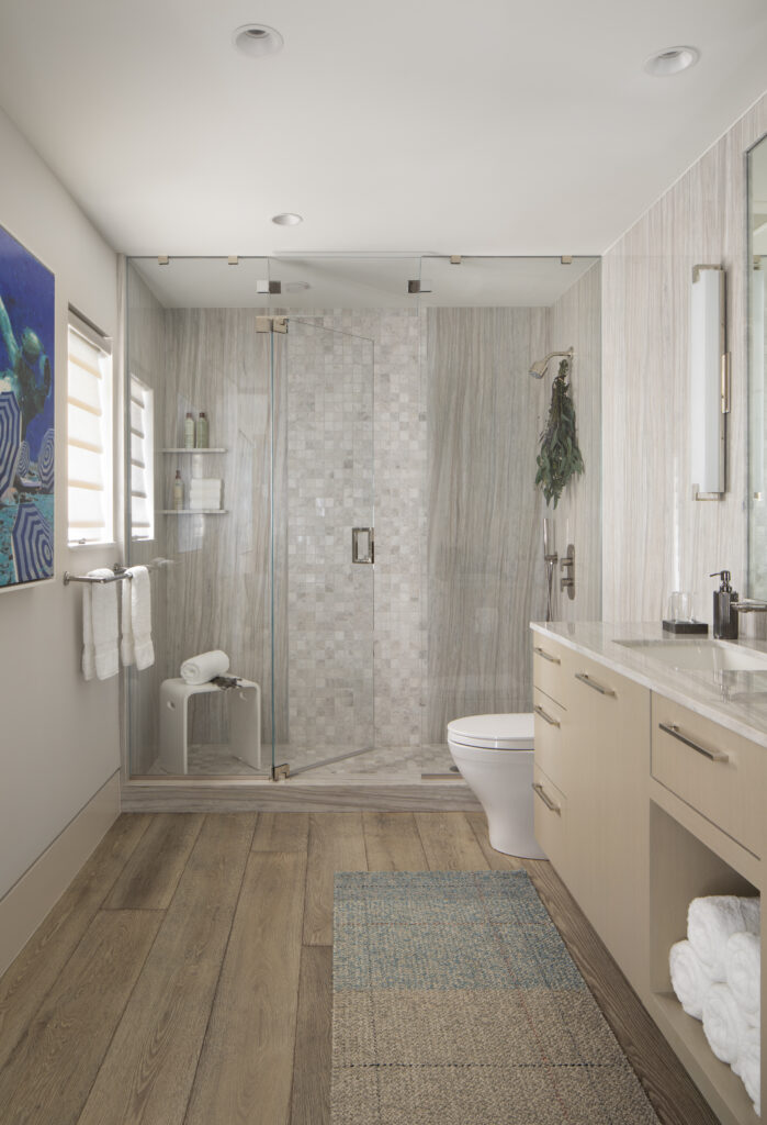 Primary bathroom suite with coastal boho aesthetic, custom tile shower and glass wall/door.