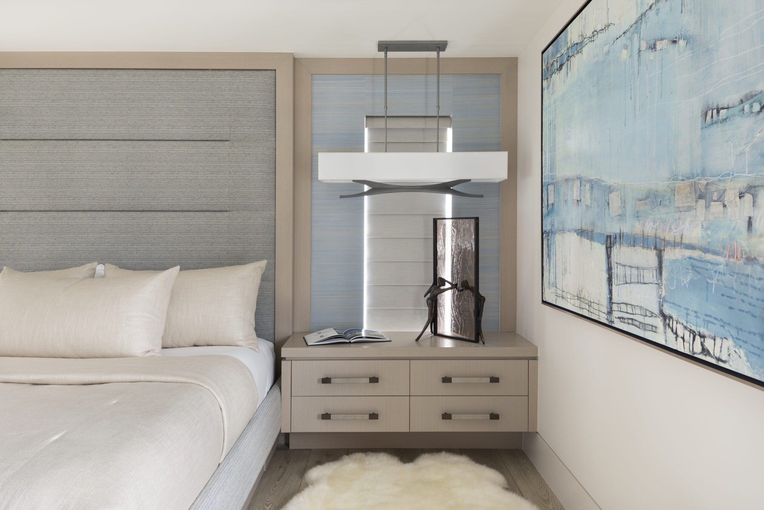 Master bedroom interior design with custom bed and wall headboard, and floating nightstands