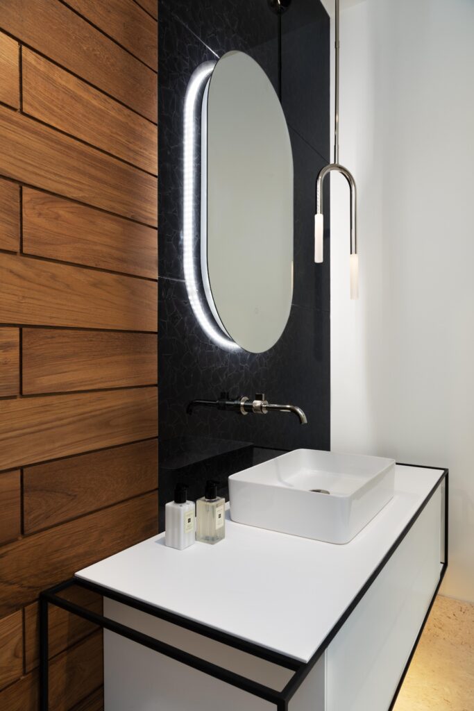 Powder bathroom interior design with floating vanity and pendant light.