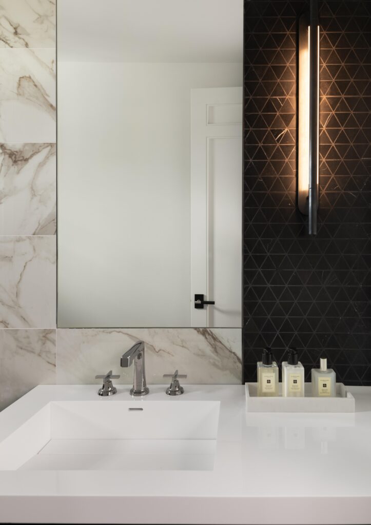 Luxury home bathroom vanity and contrasting custom tile wall.