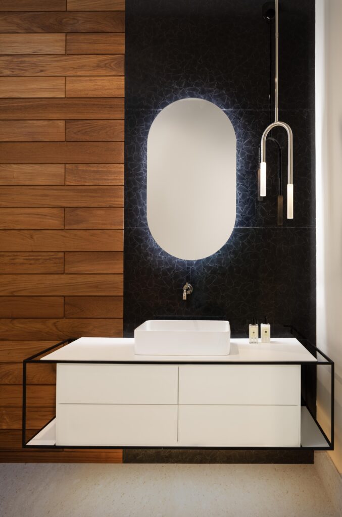 Powder bath with the juxtaposition of wood and stone, with geometric, and rectangular floating vanity.