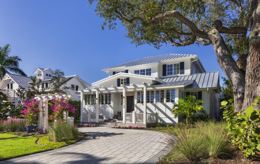 Curb appeal of modern coastal Florida home with metal roof in Naples.