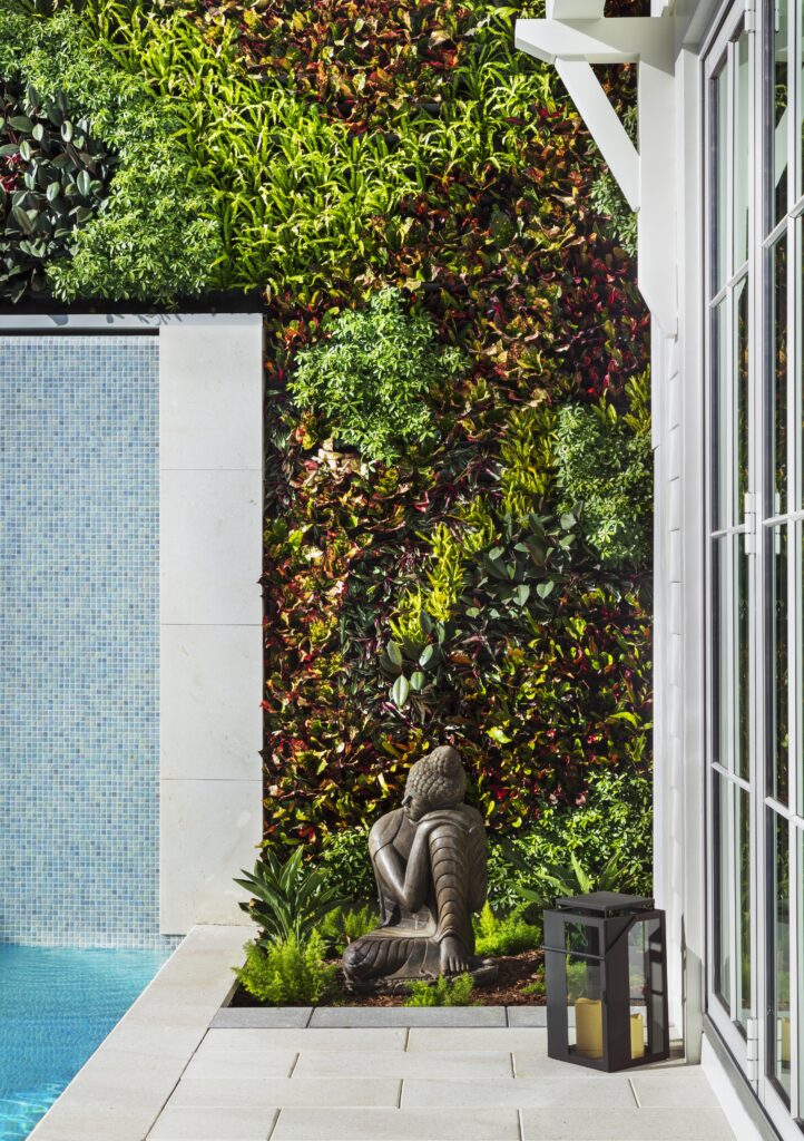 Exterior greenery wall in pool area of custom luxury home in Southwest Florida.