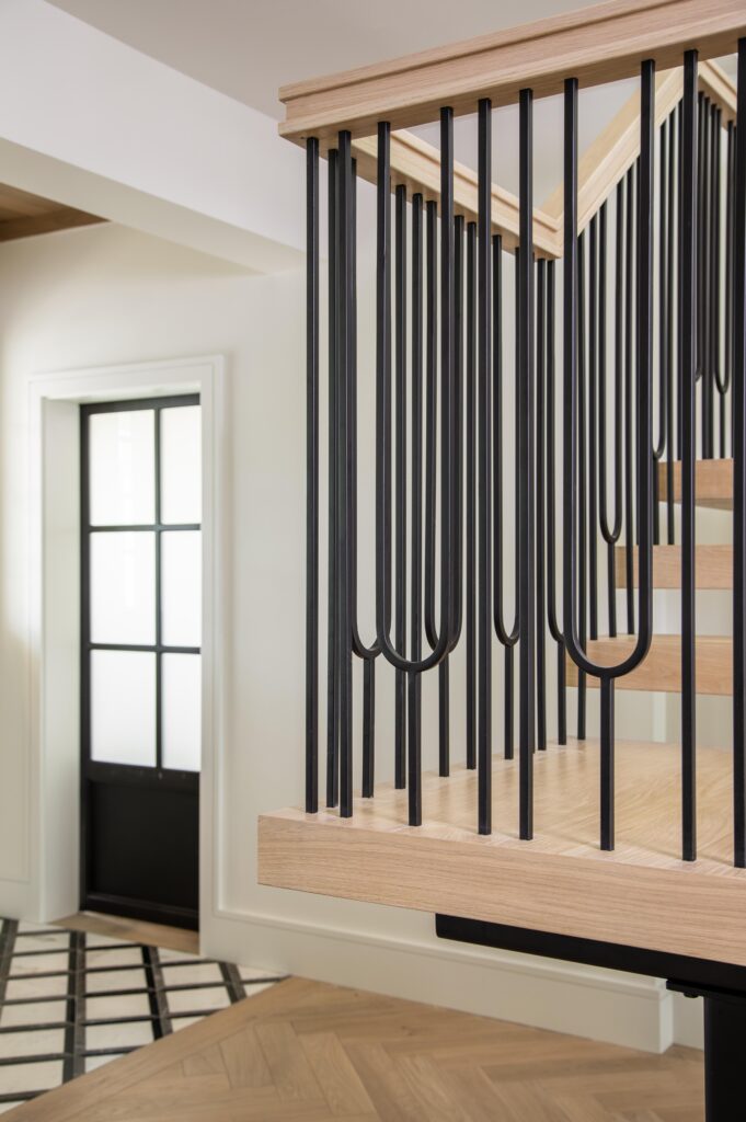 Custom staircase and railings designed by L.A. Deriggi of Hudson Park Interior Design.